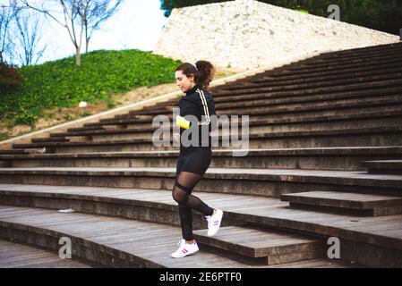 Runner athlete running on stairs. Woman fitness jogging workout concept.  Stock Photo