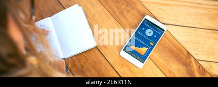 Businesswoman taking notes in agenda and mobile ethereum information Stock Photo