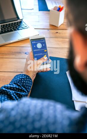 Businessman looking mobile with bitcoins information Stock Photo
