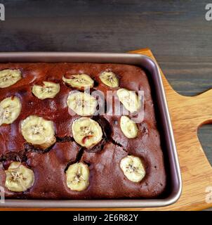 Fresh Baked Aromatic Homemade Dark Chocolate Banana Cake on the Kitchen Table Stock Photo