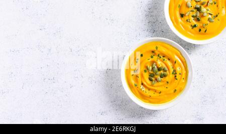 Pumpkin puree in bowl over light stone background with free text space. Healthy diet food concept. Top view, flat lay Stock Photo