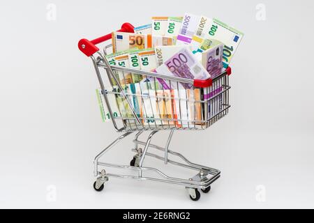 shopping cart with bundles of Euro banknotes Stock Photo