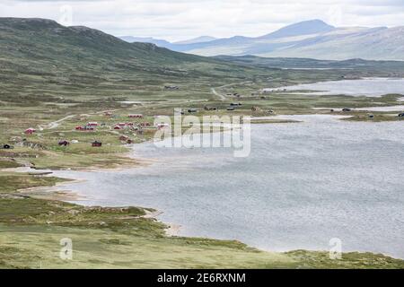 Village with red painted houses at the shore of lake Vinstri (/ Vinstre) at Jotunheimen National Park in Norway Stock Photo