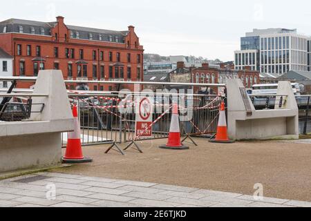 Cork, Ireland. 29th Jan, 2021. Mary Elmes Bridge Closed, Cork City. Mary Elmes Bridge was closed to pedestrians today to facilitate the cleanup and repair of the glass panes that run down the centre of the seating area of the bridge which had been badly damaged. The glass was badly smashed and bent leaving shards of glass on both sides of the bridge. Large amounts of litter could also be seen scattered throughout the bridge. Credit: Damian Coleman/Alamy Live News Stock Photo