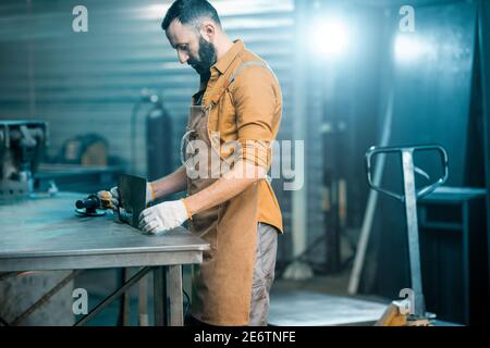 Man working with metal at the workshop Stock Photo