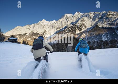 France, Haute Savoie, Mont Blanc massif, Les Contamines Montjoie, electric Fatbike on snow on the Colombaz chalets itinerary, very playful pedaling in the powder snow. Stock Photo