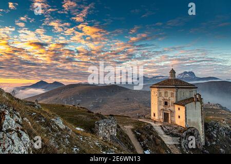 View of the Gran Sasso mountain range from Rocca Calascio. In the foreground the church of Santa Maria della Pietà. Stock Photo