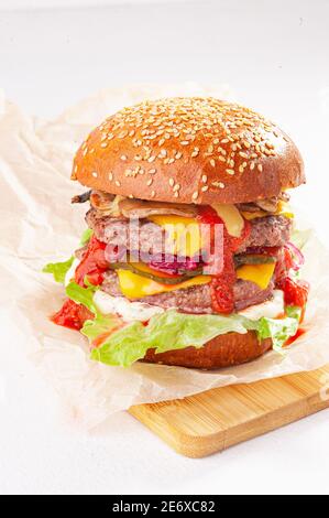 Double cheeseburger on the white background and wooden desk Stock Photo