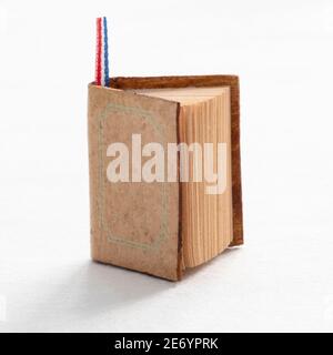 A book on the edge on a white background Stock Photo