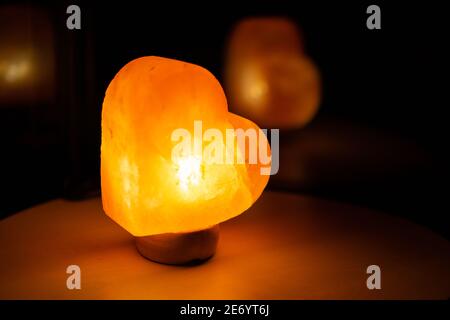 Light in heart shape on small table. Stock Photo