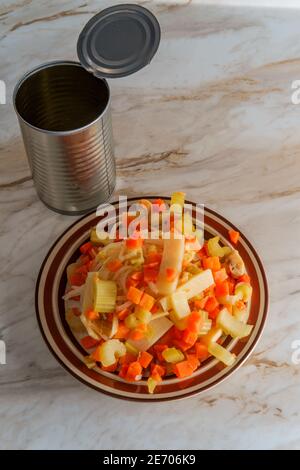 Canned Chinese food chop suey on marble kitchen table Stock Photo