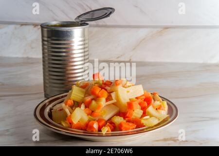 Canned Chinese food chop suey on marble kitchen table Stock Photo