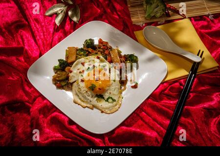 Canned Chinese food chop suey with fried sunny side up egg Stock Photo