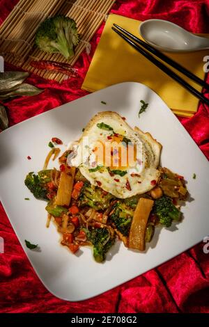 Canned Chinese food chop suey with fried sunny side up egg Stock Photo