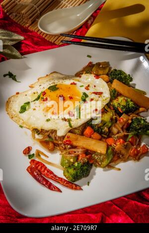 Canned Chinese food chop suey with fried sunny side up egg Stock Photo