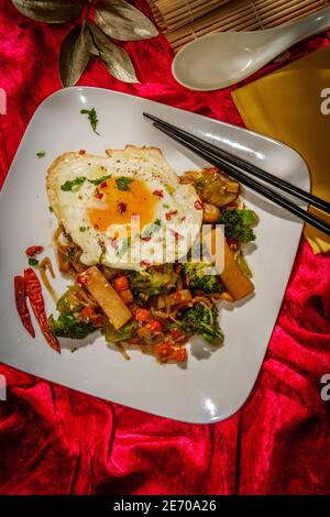 Canned Chinese food chop suey with fried sunny side up egg Stock Photo