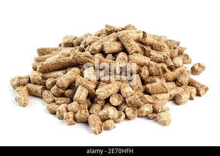 Small pile of pressed wooden dry sawdust pellets isolated on white background. Biofuel and pet litter, mulch. Stock Photo