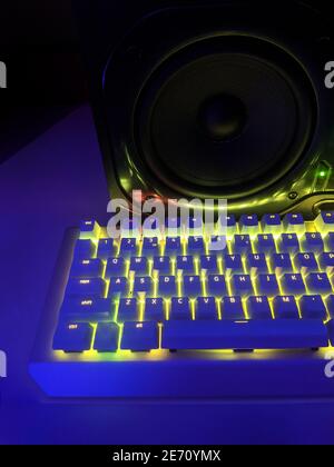 Keyboard buttons illuminated with night music from audio speaker on the background Stock Photo