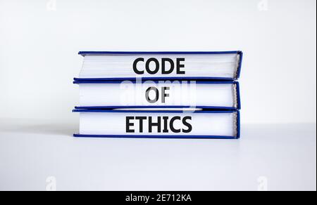 Code of ethics symbol. Books with words 'code of ethics' on beautiful white table, white background. Business and code of ethics concept. Copy space. Stock Photo