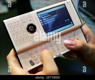 Project Partner Willcom Inc Employee Shows The New Product W Zero3 Es Mobile Device In Tokyo July 4 06 Reuters Toshiyuki Aizawa Japan Stock Photo Alamy