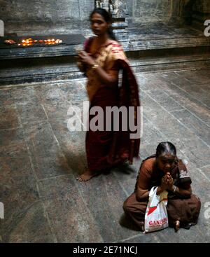 Hindu worshippers make offerings to their gods & goddesses at a Ganga ...