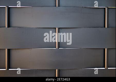 detail of a metal fence with slats and bars in modern style painted black Stock Photo