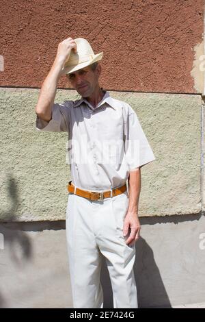 senior gentleman takes off his hat with his hand Stock Photo