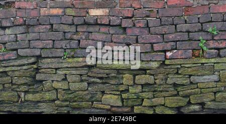 Old wall constructed with two types of bricks Stock Photo