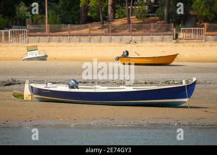 Traditional Pinasse boat is beached on a sand bank in the Arcachon bay, Gironde, France, Europe. It is a typical wooden boat very common in this area Stock Photo