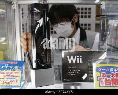 An employee arranges Nintendo Co's game software titles at a ...