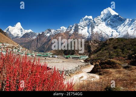 view of Khumjung village and beautiful himalayas near Namche bazar, Ama Dablam, kangtega and Thamserku - Way to Everest base camp - Nepal Stock Photo