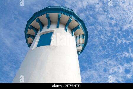 iconic lighthouse at Fisherman's Village in Marina Del Rey, California USA on a sunny day under puffy clouds Stock Photo
