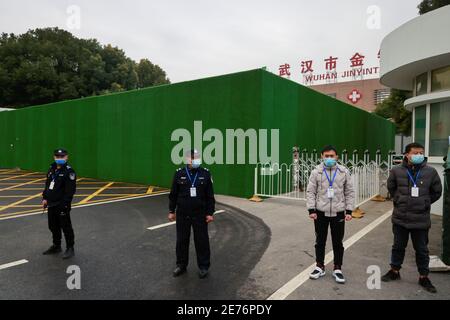 Security personnel stand outside Jinyintan Hospital after a team of the World Health Organisation (WHO), tasked with investigating the origins of the coronavirus (COVID-19) pandemic, entered its compound in Wuhan, Hubei province, China, January 30, 2021. REUTERS/Thomas Peter