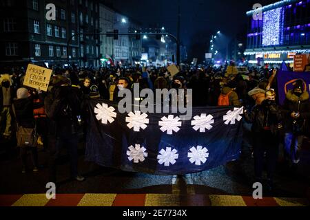 Kracow, Poland. 27th Jan, 2021. Protesters hold a banner with a symbol of so-called Eight Star Movement during the demonstration.After the Polish Constitutional Court verdict to implement one of the most restrictive anti-abortion laws in Europe came into effect on January 27th, hundreds of Poles took the streets in all major cities. Protests organized by the by the Women's Strike broke out again after the new anti-abortion bill was finally passed. Credit: SOPA Images Limited/Alamy Live News Stock Photo