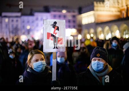 Kracow, Poland. 27th Jan, 2021. A protester wearing a face mask holds a placard during the demonstration.After the Polish Constitutional Court verdict to implement one of the most restrictive anti-abortion laws in Europe came into effect on January 27th, hundreds of Poles took the streets in all major cities. Protests organized by the by the Women's Strike broke out again after the new anti-abortion bill was finally passed. Credit: SOPA Images Limited/Alamy Live News Stock Photo