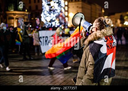 Kracow, Poland. 27th Jan, 2021. A protester chants slogans on a megaphone during the demonstration.After the Polish Constitutional Court verdict to implement one of the most restrictive anti-abortion laws in Europe came into effect on January 27th, hundreds of Poles took the streets in all major cities. Protests organized by the by the Women's Strike broke out again after the new anti-abortion bill was finally passed. Credit: SOPA Images Limited/Alamy Live News Stock Photo