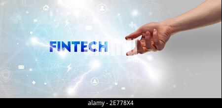 Hand pointing at FINTECH inscription, modern technology concept Stock Photo