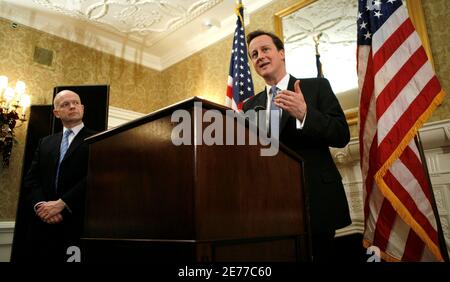 Britain's Conservative Party leader David Cameron speaks to reporters with shadow foreign secretary William Hague at his side, in a hotel, after a meeting with U.S. President George W. Bush at the White House, in Washington, November 29, 2007. REUTERS/Kevin Lamarque   (UNITED STATES)