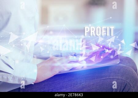 Close up hands using tablet with PROFIT inscription, modern business technology concept