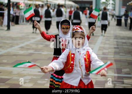 Iranian children hold national flags during a ceremony at the Shanghai World Expo site on Iran's Pavilion Day, June 11, 2010. REUTERS/Aly Song (CHINA - Tags: SOCIETY BUSINESS)