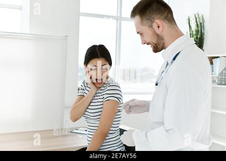 emotional woman afraid of injections vaccination hospital treatment Stock Photo