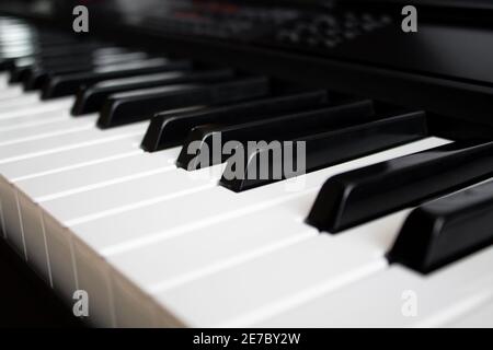 Electronic piano keyboard closeup. Black and white keys of the synthesizer Stock Photo