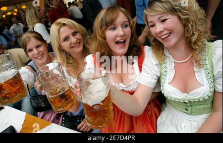 Girls in traditional Bavarian clothes toast with beer at Munich's Oktoberfest  October 3, 2006. The world's biggest beer festival, which drew about 6  million visitors, ended today. REUTERS/Michaela Rehle (GERMANY Stock Photo  - Alamy