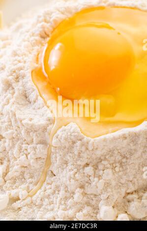 food background texture of a broken egg in flour close-up Stock Photo