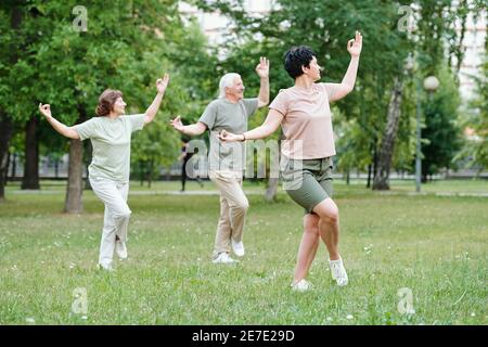 Mature women exercising together in the park outdoors Stock Photo