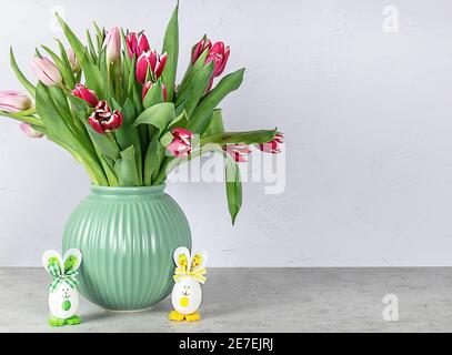 Easter greeting card with eggs bunny and tulips flowers. Stock Photo