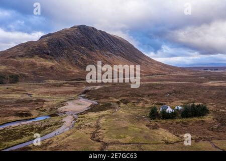 Flying drone dramatic landscape image of mountains rivers and valleys in Glencoe in Scottish Highlands on a Winter day Stock Photo