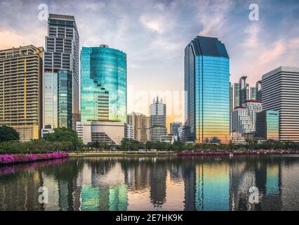 Skyscrapers Reflected in a Lake at Twilight. Benjakiti Park in Bangkok, Thailand Stock Photo