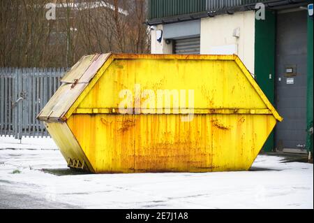Large yellow skip outside industrial business unit Stock Photo