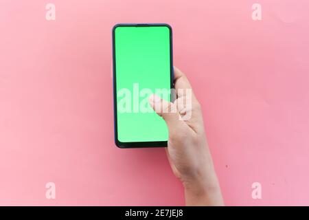 top view of women hand using smart phone on pink  Stock Photo